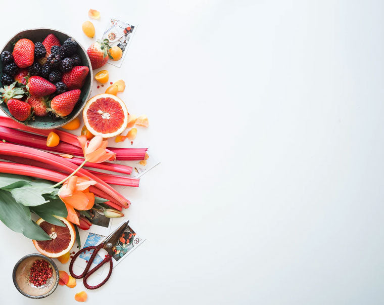 Stack of fresh fruit on a white table